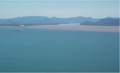 Brown water from a river flood plume flowing into the ocean.